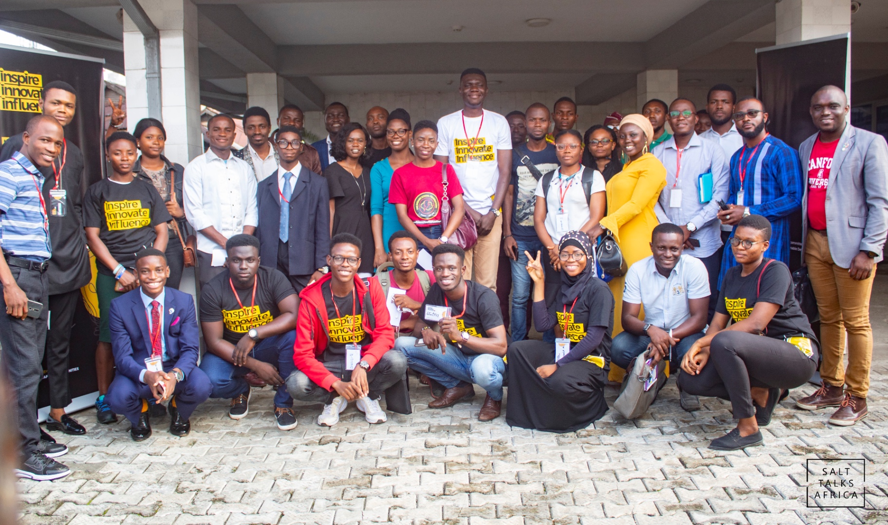 Large group of young Salt House Africa participants gathered outdoors after a program session