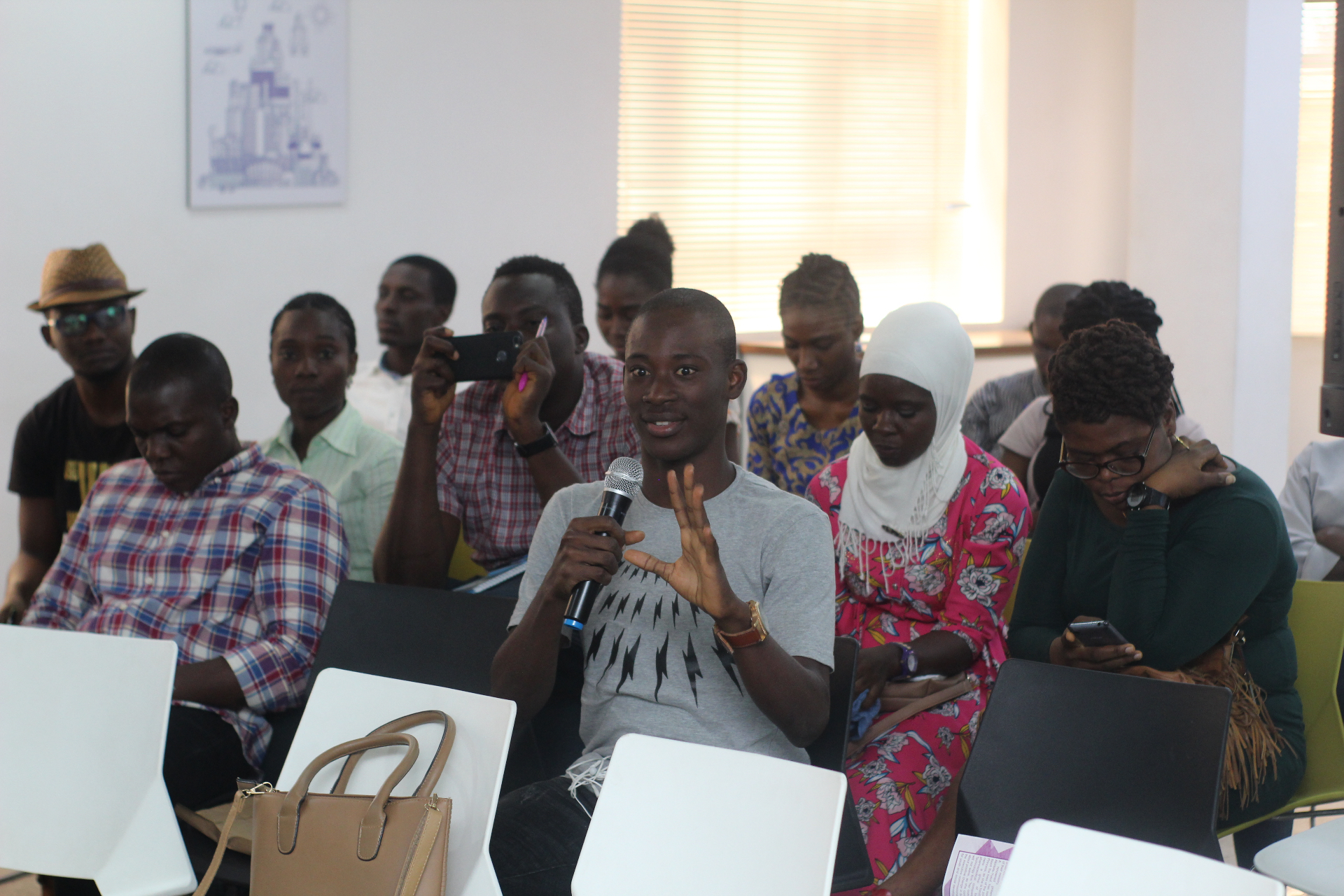 A speaker addressing an audience with a microphone at a Salt House Africa event