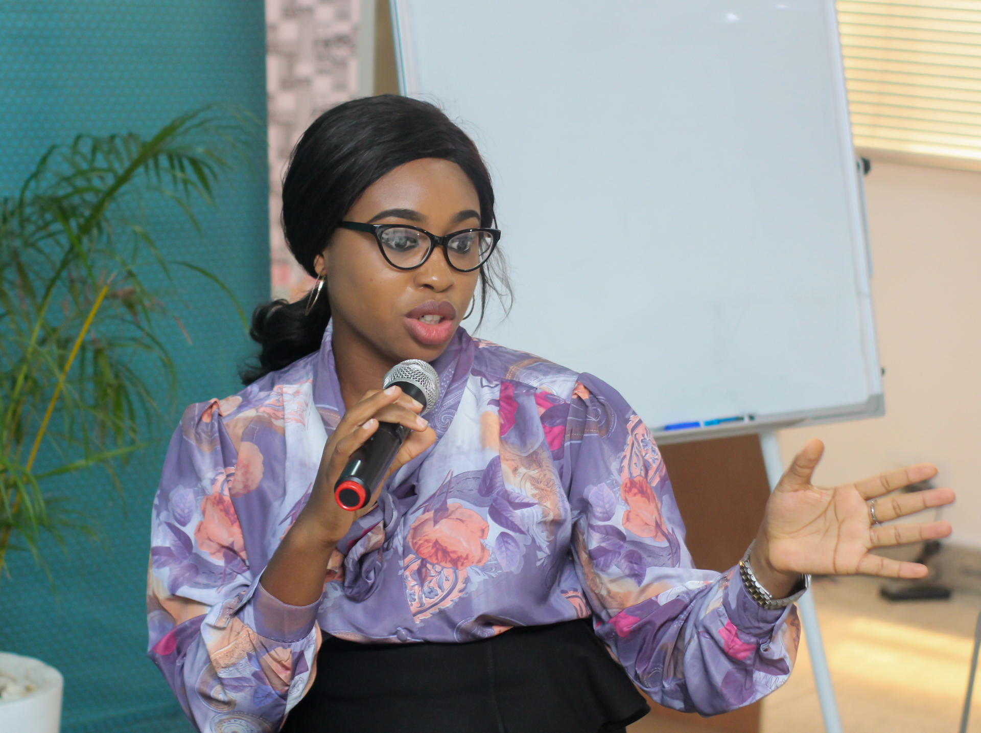 A facilitator speaking into a microphone during a Salt House Africa workshop