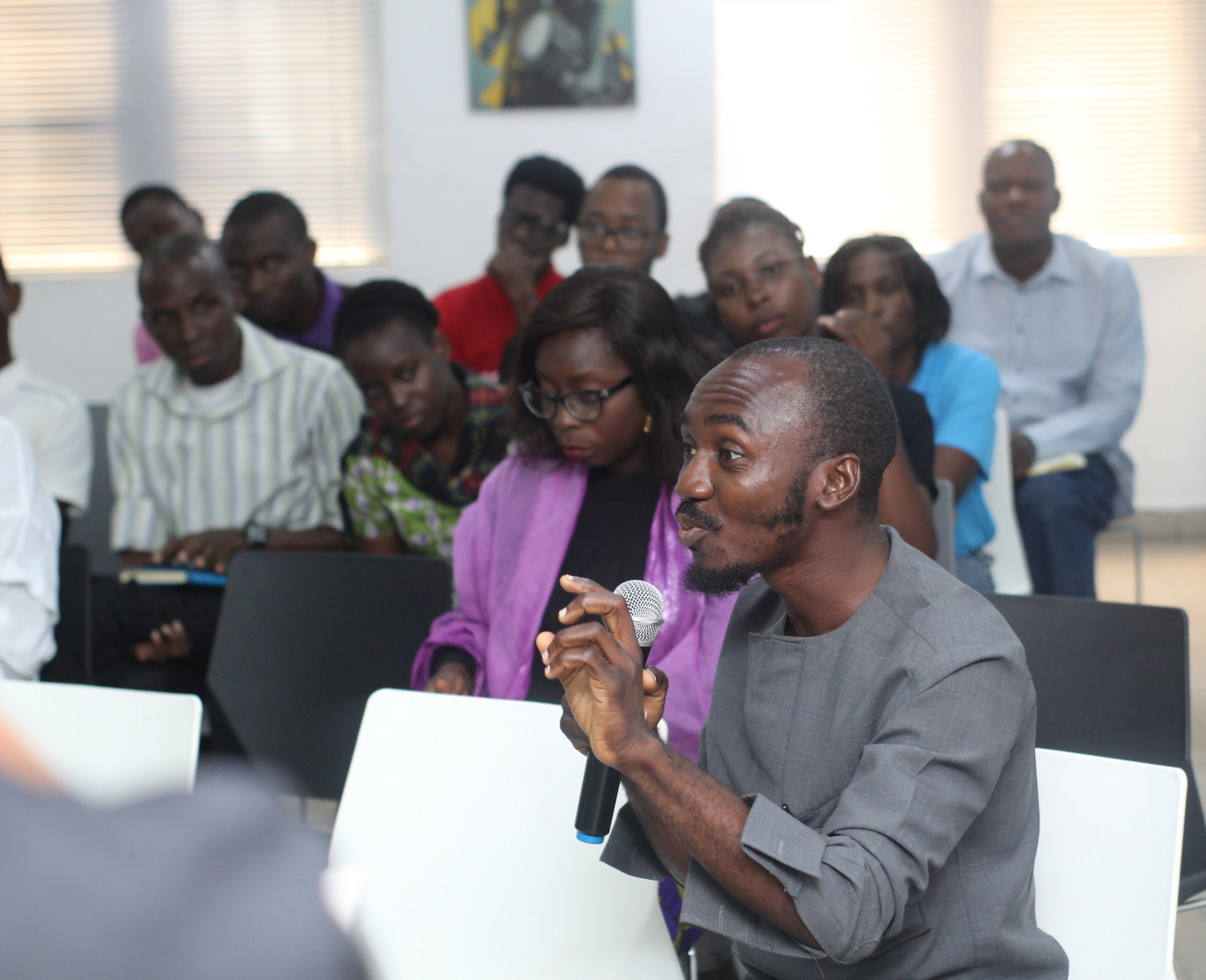 A speaker addressing a full room during an Inclusion Dialogue recording