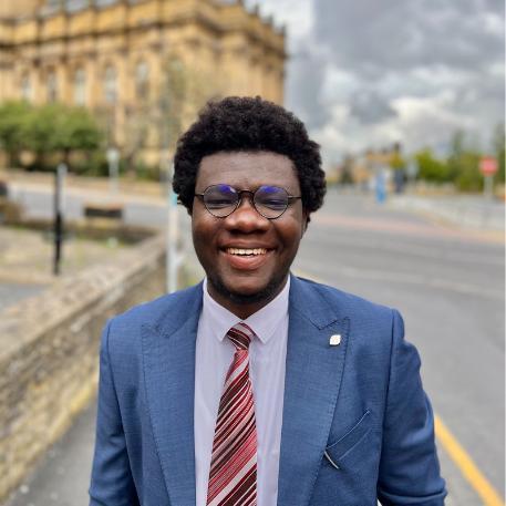 Portrait of the director of Salt House Africa in a blue suit and glasses