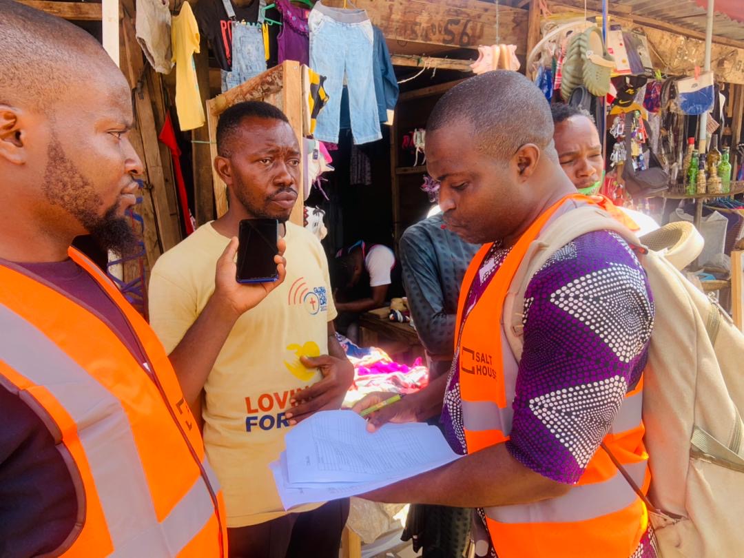 A citizen being supported to use a public digital service on a phone